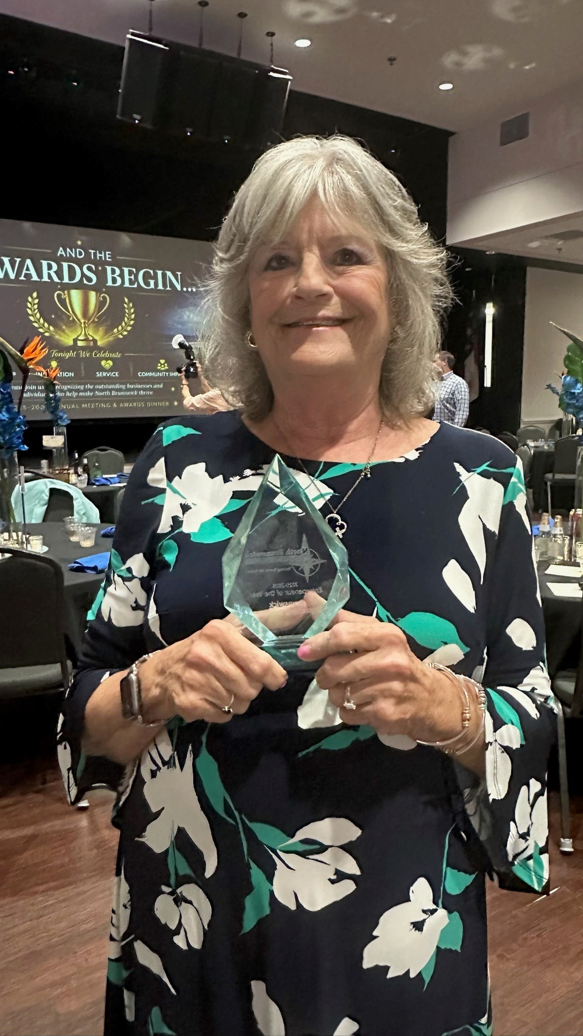 Karen Wrenn accepts the Entrepreneur of the Year award from the North Brunswick Chamber of Commerce